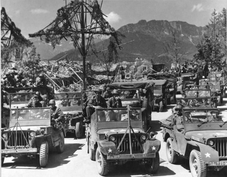 US Army troops en route for some Rest and Recreation in Germany, May or Jun 1945; note Jeeps with modified wrap-around front fenders and/or anti-decapitation bars